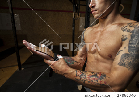 Male athlete wearing gymnastics grips for pull up 27866340