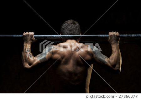 Male muscular athlete doing pull up exercise 27866377