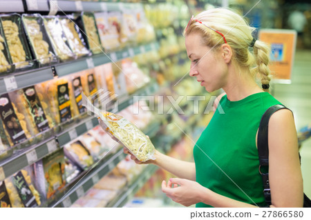Woman shopping groceries at supermarket. Woman shopping groceries at supermarket. 27866580
