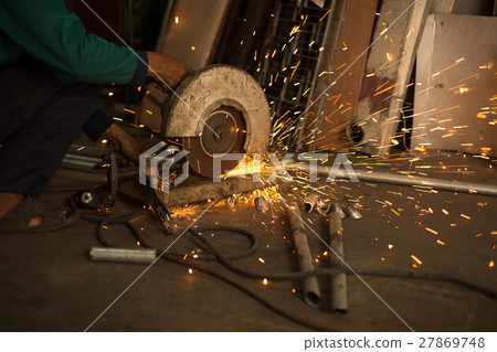Worker use Electric grinder cutting metal Worker use Electric grinder cutting metal 27869748