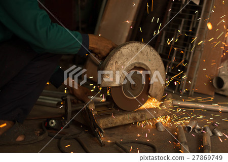 Worker use Electric grinder cutting metal Worker use Electric grinder cutting metal 27869749