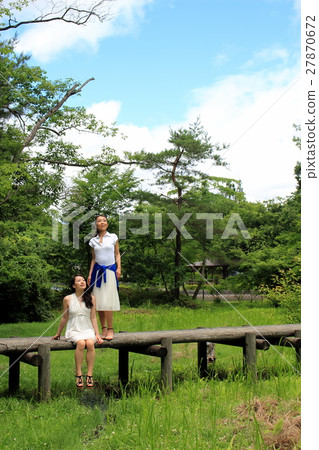 A woman looking at a distant place on the bridge A woman looking at a distant place on the bridge 27870672