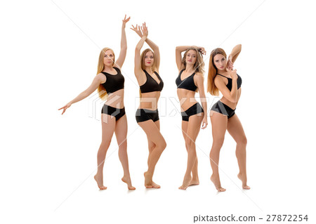 Slim sportswomen in tops and pants pose in stidio Slim sportswomen in tops and pants pose in stidio 27872254