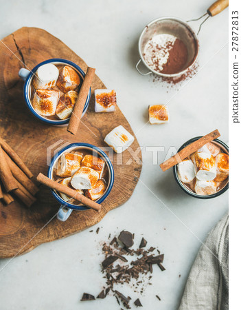 Hot chocolate in enamel mugs with cinnamon and Hot chocolate in enamel mugs with cinnamon and 27872813