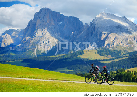 Tourists cycling in Seiser Alm Tourists cycling in Seiser Alm 27874389