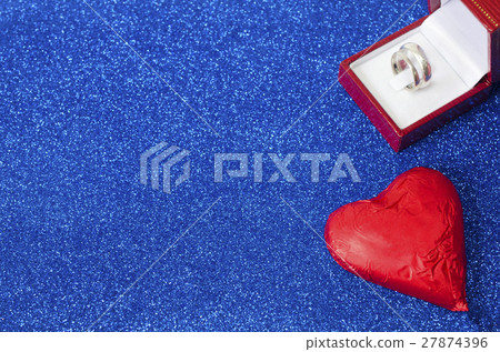 chocolate heart and ring on blue background chocolate heart and ring on blue background 27874396