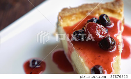 Cheesecake piece topped with fruit sauce Cheesecake piece topped with fruit sauce 27876823