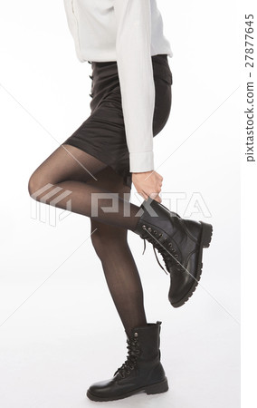 businesswoman adjusting shoes businesswoman adjusting shoes 27877645