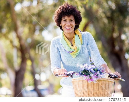 Happy young woman with bicycle Happy young woman with bicycle 27878245