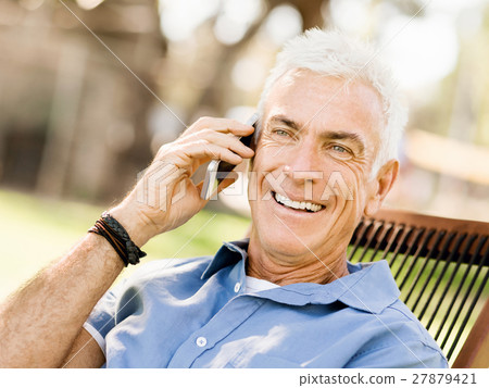 LoMature man outdoors using mobile phone LoMature man outdoors using mobile phone 27879421