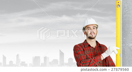 Builder checking spirit level 27879560