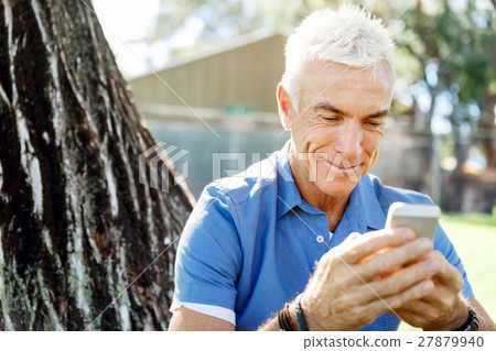 LoMature man outdoors using mobile phone LoMature man outdoors using mobile phone 27879940