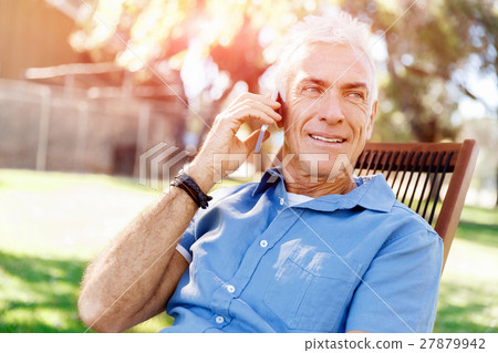 LoMature man outdoors using mobile phone LoMature man outdoors using mobile phone 27879942