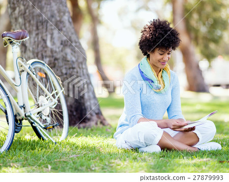 Young woman using tablet in the park. 27879993