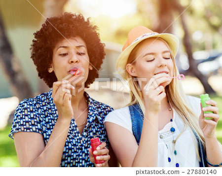Two women friends in park Two women friends in park 27880140