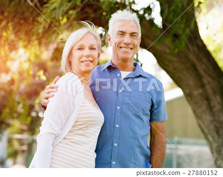Senior couple relaxing in park Senior couple relaxing in park 27880152