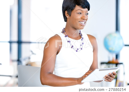 Young woman in office using tablet Young woman in office using tablet 27880254