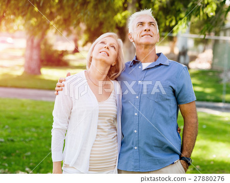 Senior couple relaxing in park Senior couple relaxing in park 27880276