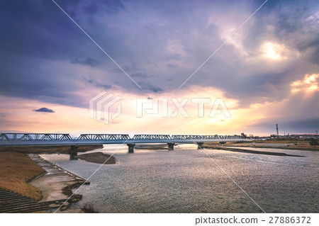 Evening scenery of the iron bridge over the river 27886372