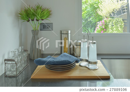 Dishes and glass bottles setting on counter top 27889106