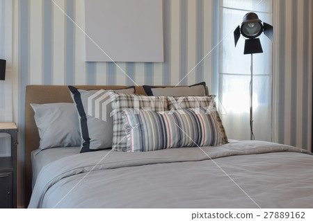 stylish bedroom with striped pillows on bed stylish bedroom with striped pillows on bed 27889162