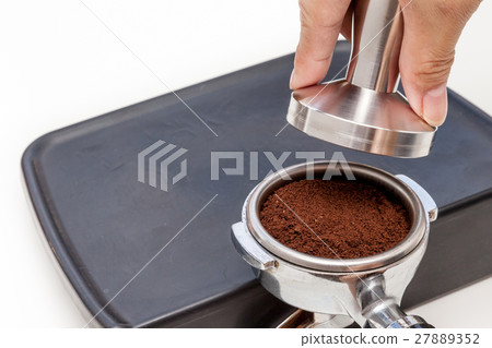 Barista is tamping coffee ground on the rubber Barista is tamping coffee ground on the rubber 27889352