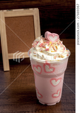 Pink milk shake with marshmellows topping on  27889367