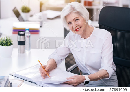 Smiling aged business lady performing her Smiling aged business lady performing her 27891609
