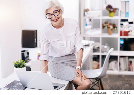 Amused funny business lady using the device in the 27891612