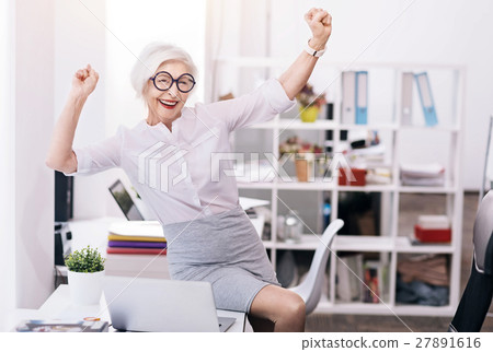 Glad happy business lady expressing joy at the 27891616