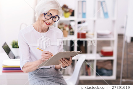 Involved happy business lady writing at the Involved happy business lady writing at the 27891619