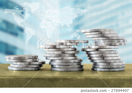 Coin stacks and digital network with world map 27894407