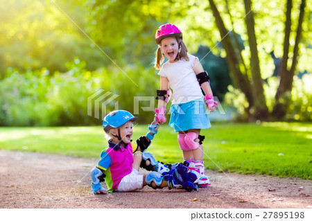 Kids roller skating in summer park 27895198