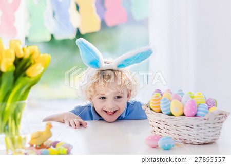 Child with bunny ears on Easter egg hunt Child with bunny ears on Easter egg hunt 27895557
