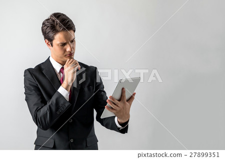 A man looking at a tablet 27899351