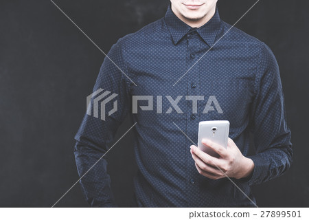 A man operating a smartphone A man operating a smartphone 27899501
