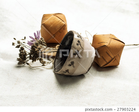 Clay pot and small wooden boxes placed on linen Clay pot and small wooden boxes placed on linen 27903224