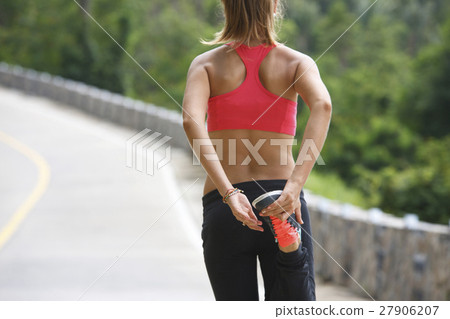 fitness woman running at tropical forest trail 27906207