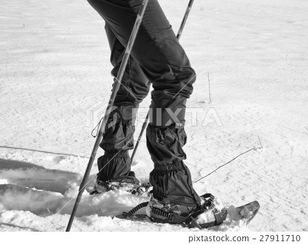 Man legs with snowshoes walk  in snowdrift 27911710