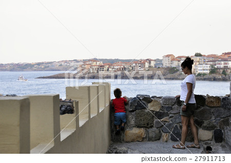 Son and mother walking on street of ?ncient city of Sozopol in Bulgaria 27911713