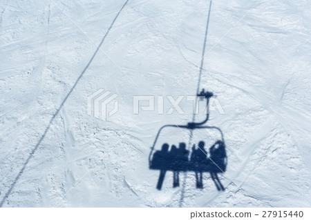Skiers on a ski lift Skiers on a ski lift 27915440