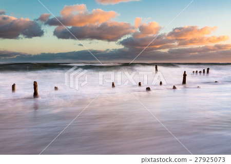 Groynes on shore of the Baltic Sea on a stormy day 27925073