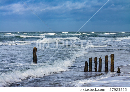Groynes on shore of the Baltic Sea on a stormy day 27925233