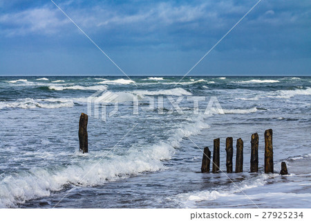 Groynes on shore of the Baltic Sea on a stormy day 27925234