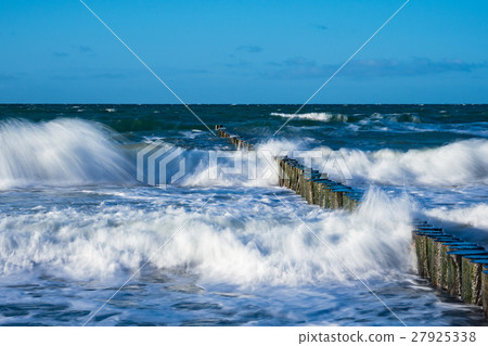 Groynes on shore of the Baltic Sea on a stormy day 27925338