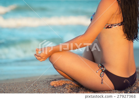 Young woman in the lotus pose closeup 27927368