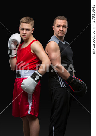 Young boxer working out with coach Young boxer working out with coach 27929642