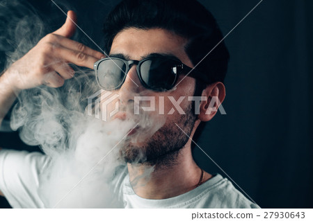 Young cool guy in sunglasses exhales a cloud of Young cool guy in sunglasses exhales a cloud of 27930643