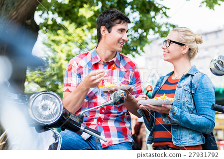 Tourist couple taking rest during scooter tour  27931792