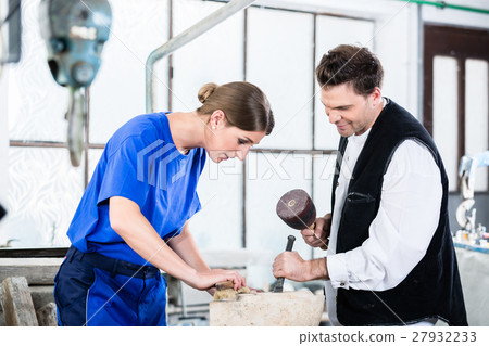 two Stonemasons carving pillar out of stone 27932233